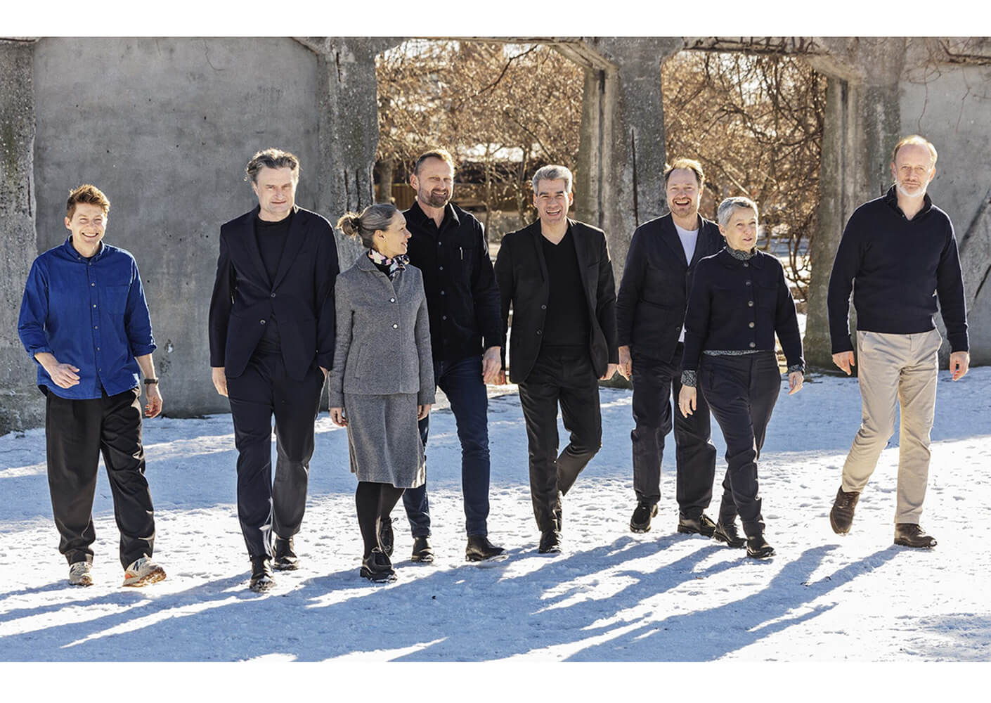 eight people walking in snow