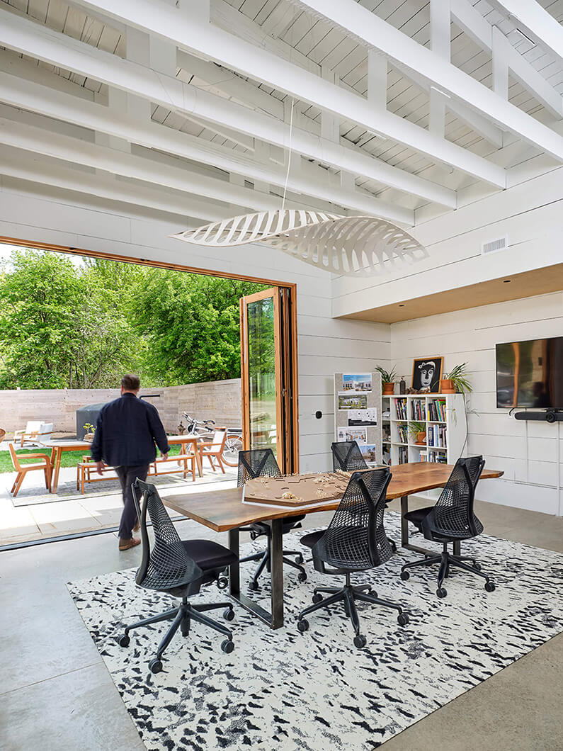 a meeting room with open doors to a patio