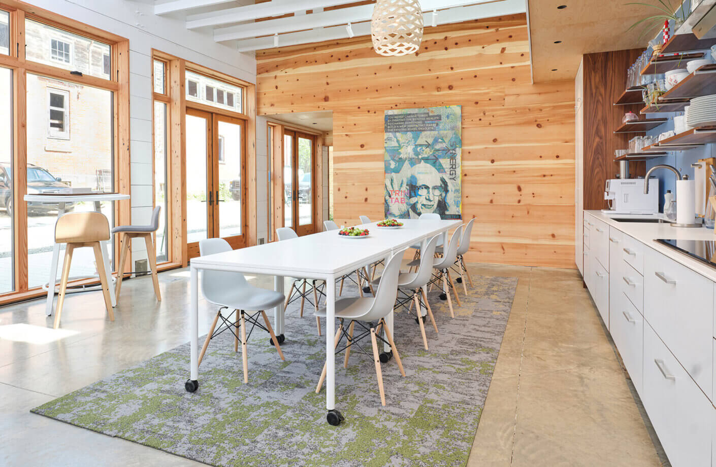 the studio dining room with a kitchenette and wood walls