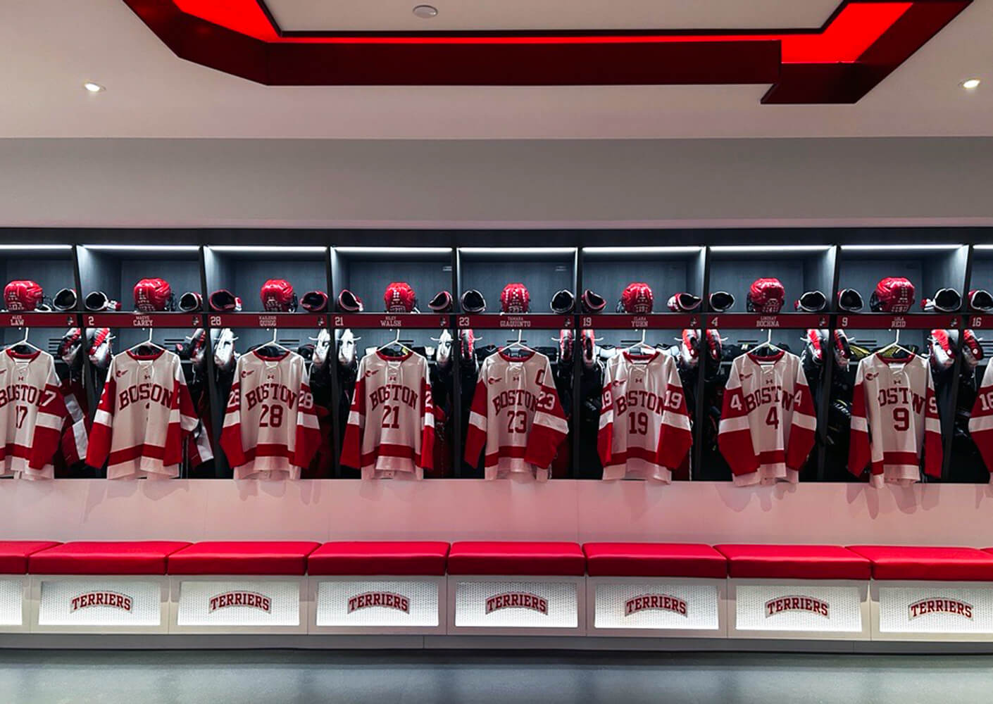 Women's ice hockey locker room with jerseys hung up