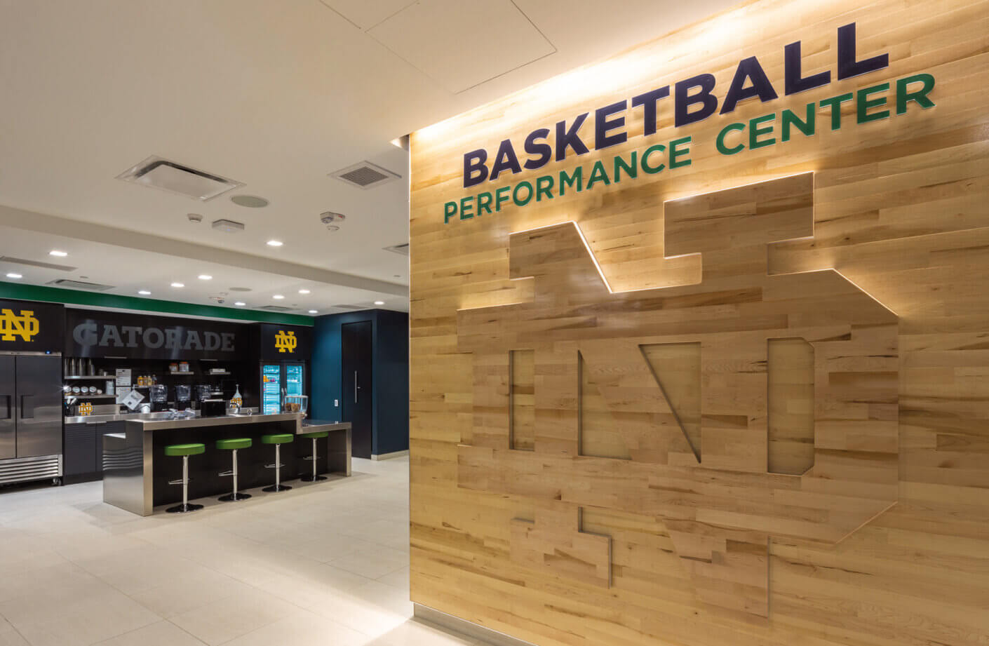 Athletic tea, nutrition station in the background with branded wood panel wall in the foreground