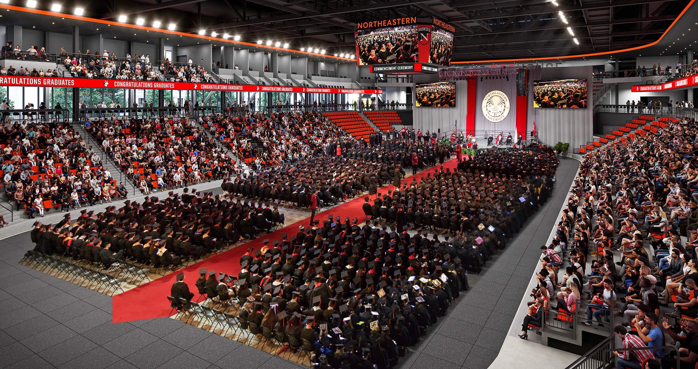 Arena in use for a commencement ceremony with students on stage and guests in stands