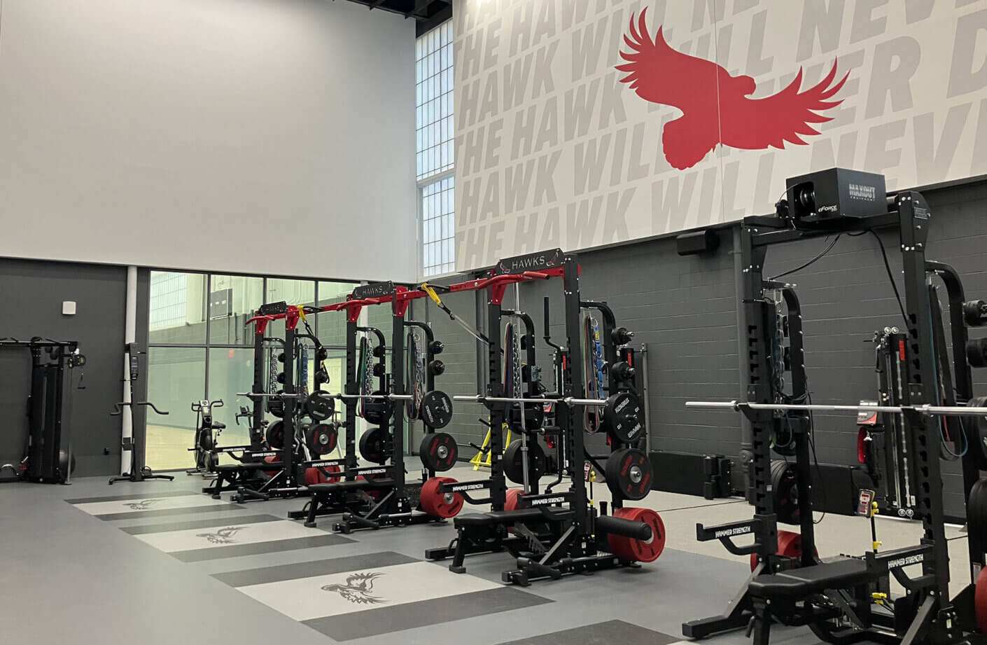 Weight training room with window to basketball court