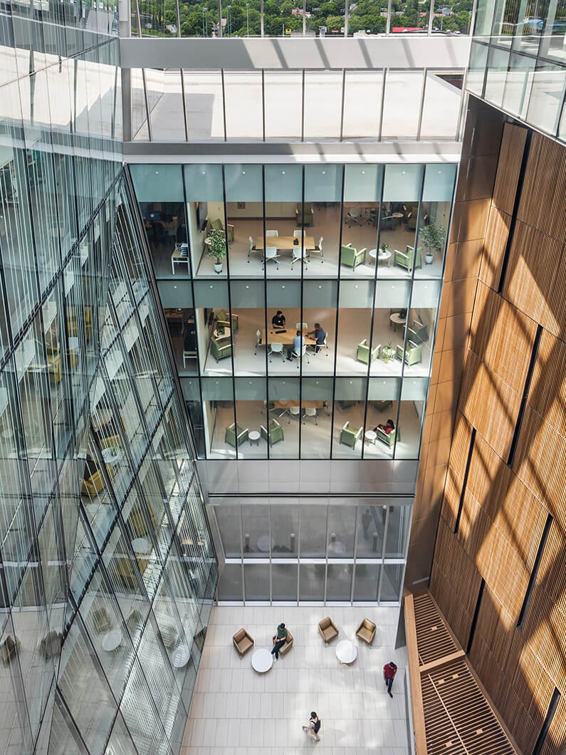 a large atrium with curved glass fenestration
