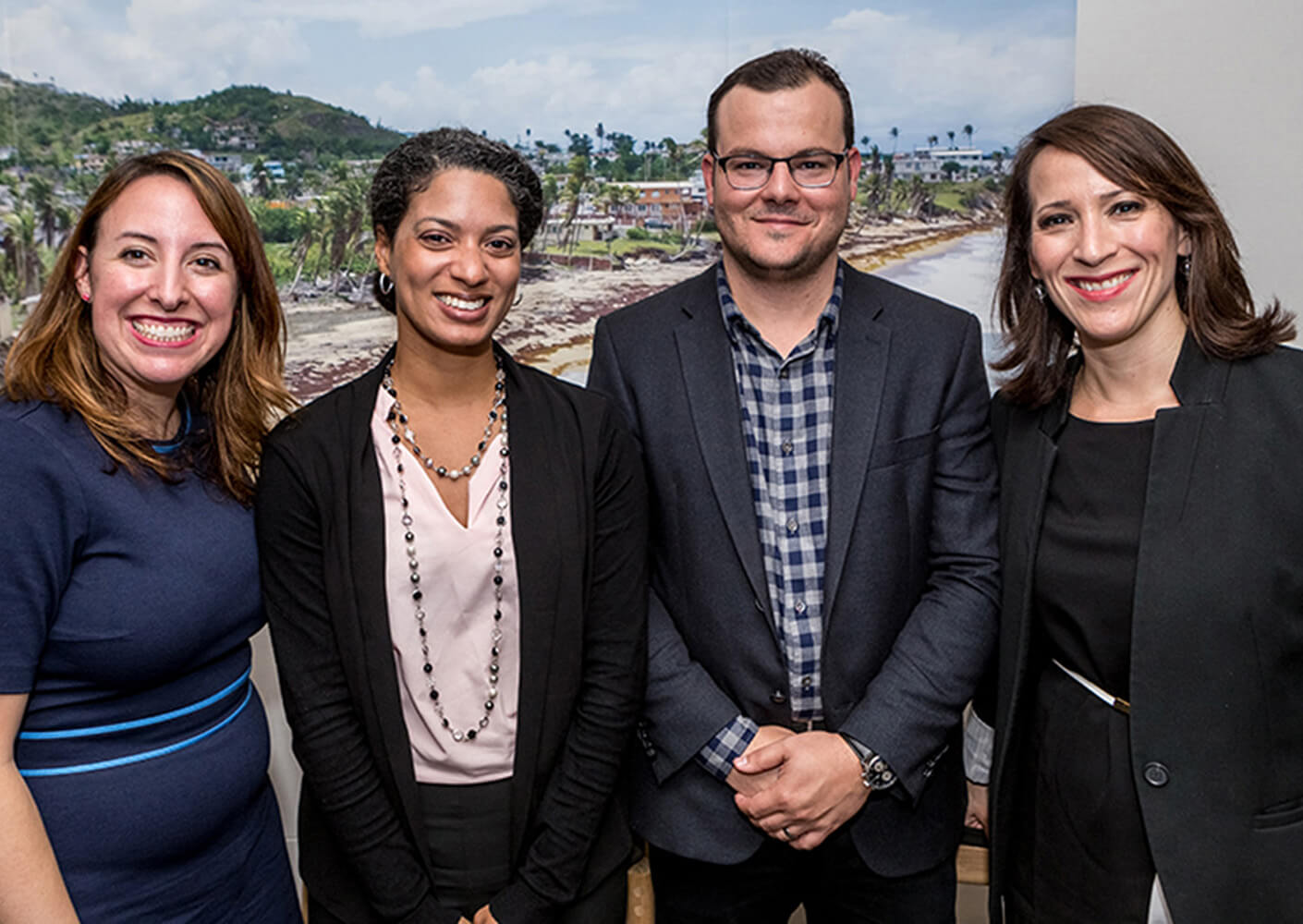 four people smiling and posed for a photo