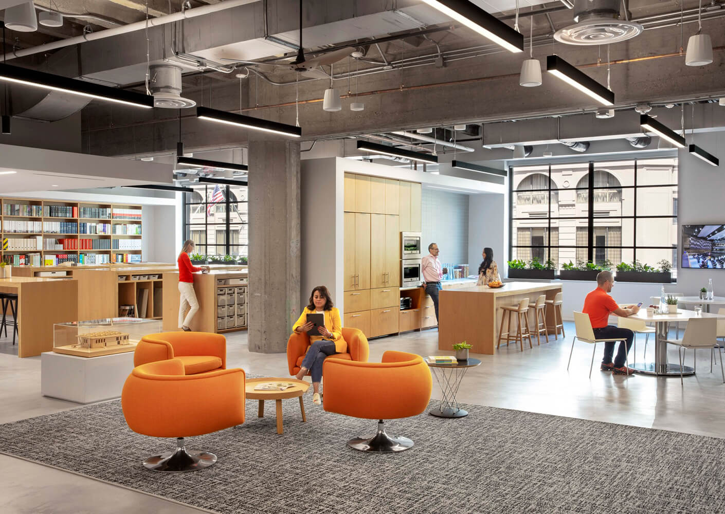 Lobby of an open office with people working and sitting