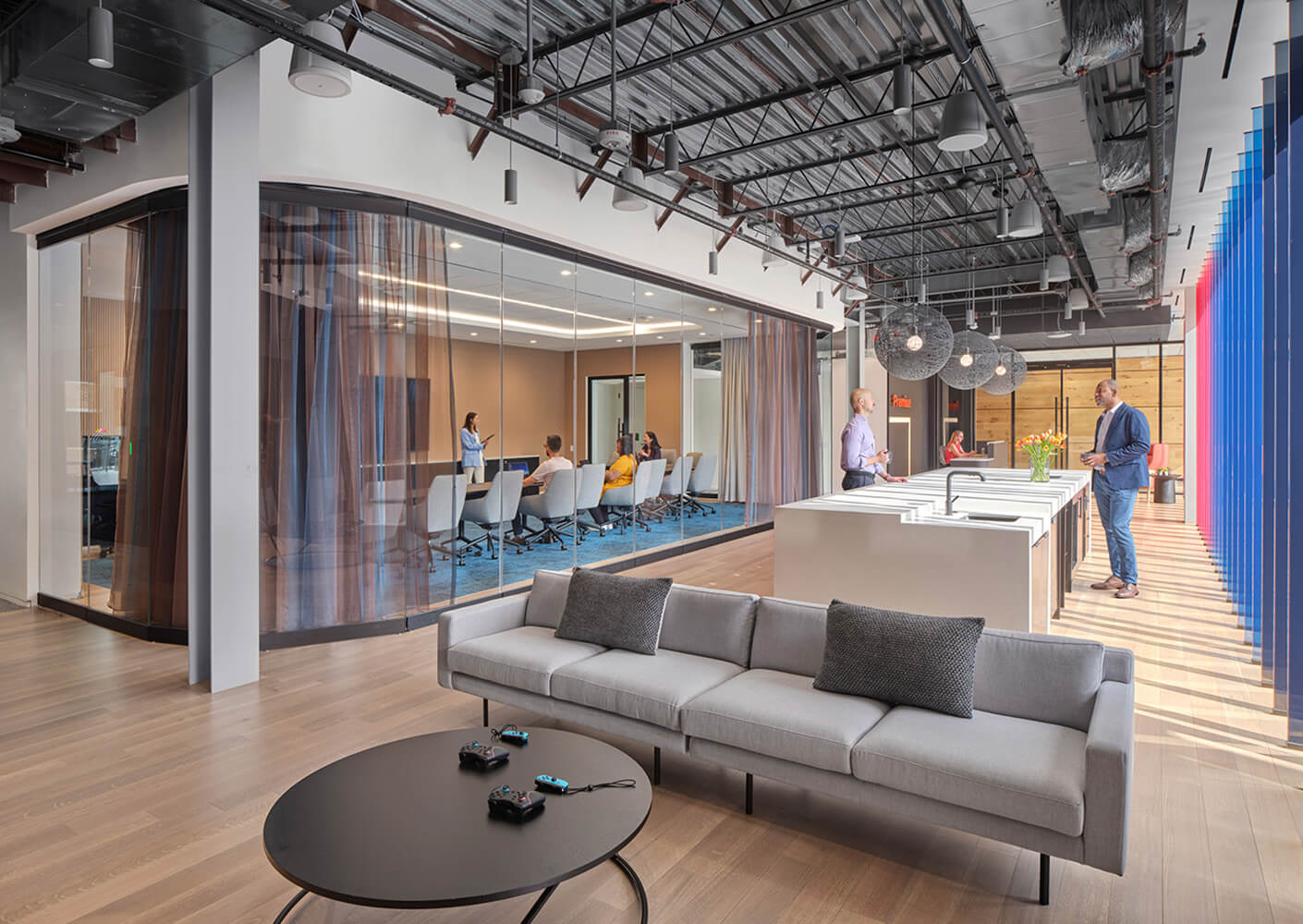 Office space with people working in a large conference room