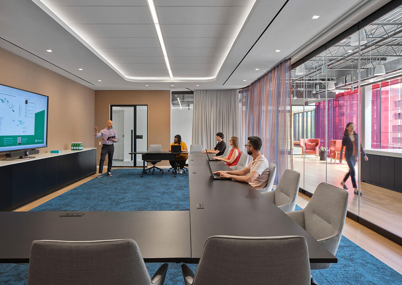 Office space with people working in a large conference room