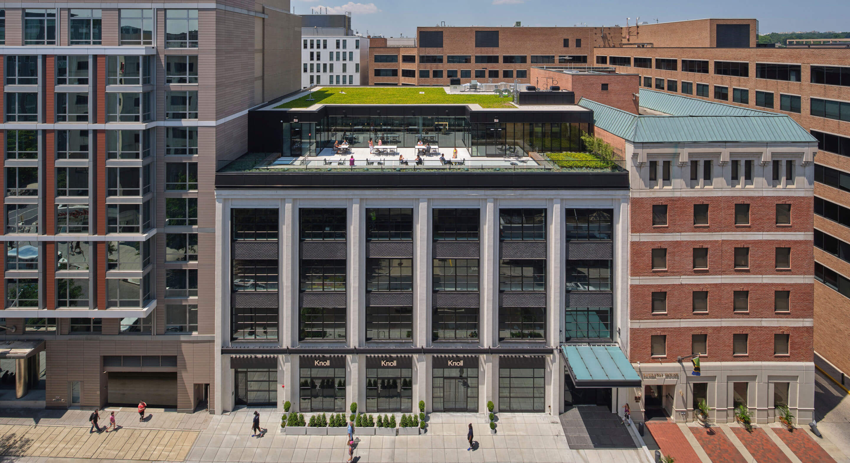 Aerial drone image showing exterior of industrial city buildings with people walking on street