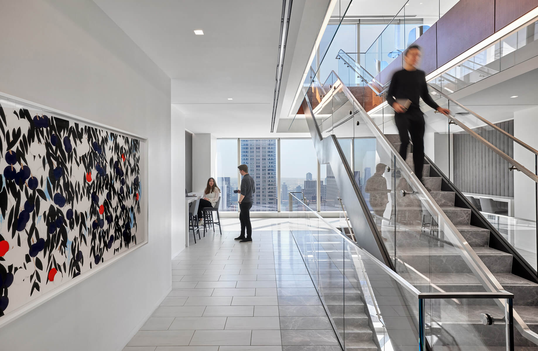 person walking down interconnecting stair and people talking in cafe in back