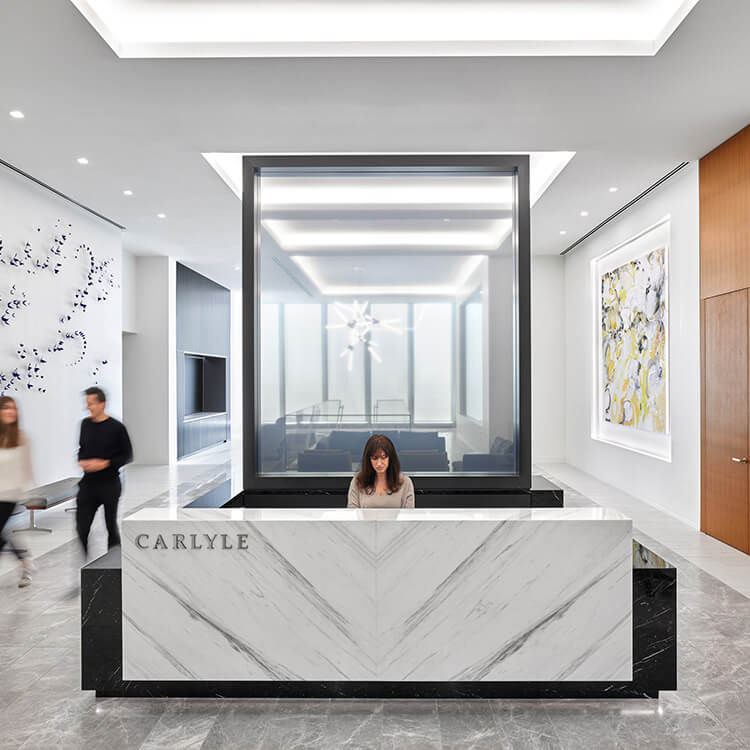 Entry area of office with person sitting at front desk