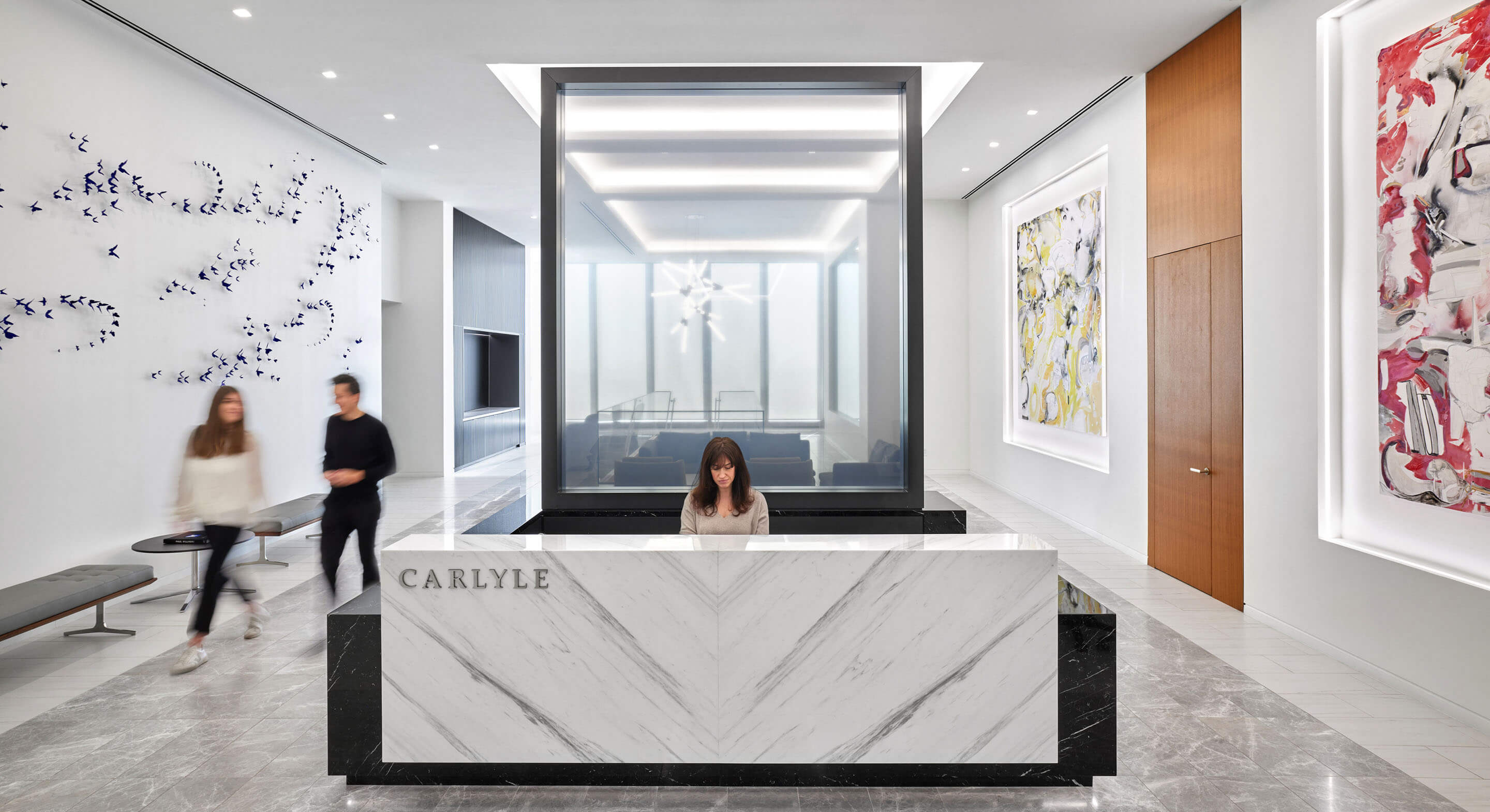 Entry area of office with person sitting at front desk