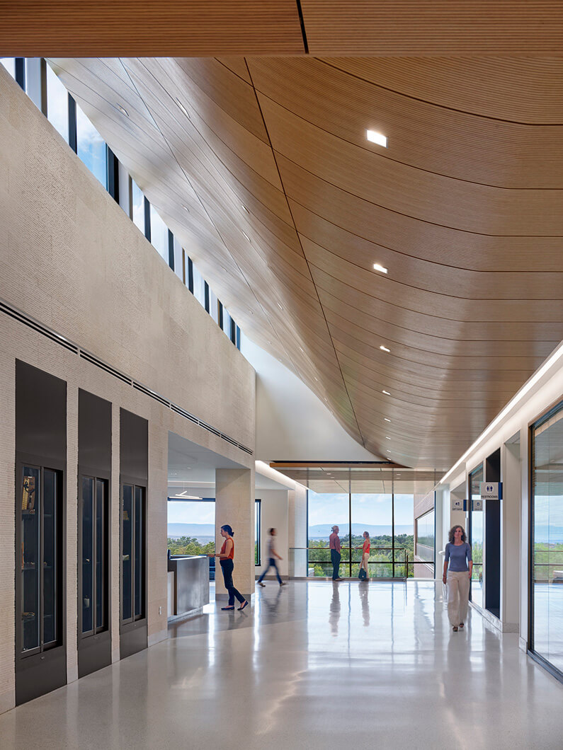 Hallway of healthcare facility with people walking down