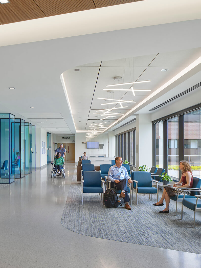 waiting lobby of healthcare facility with people sitting in chairs