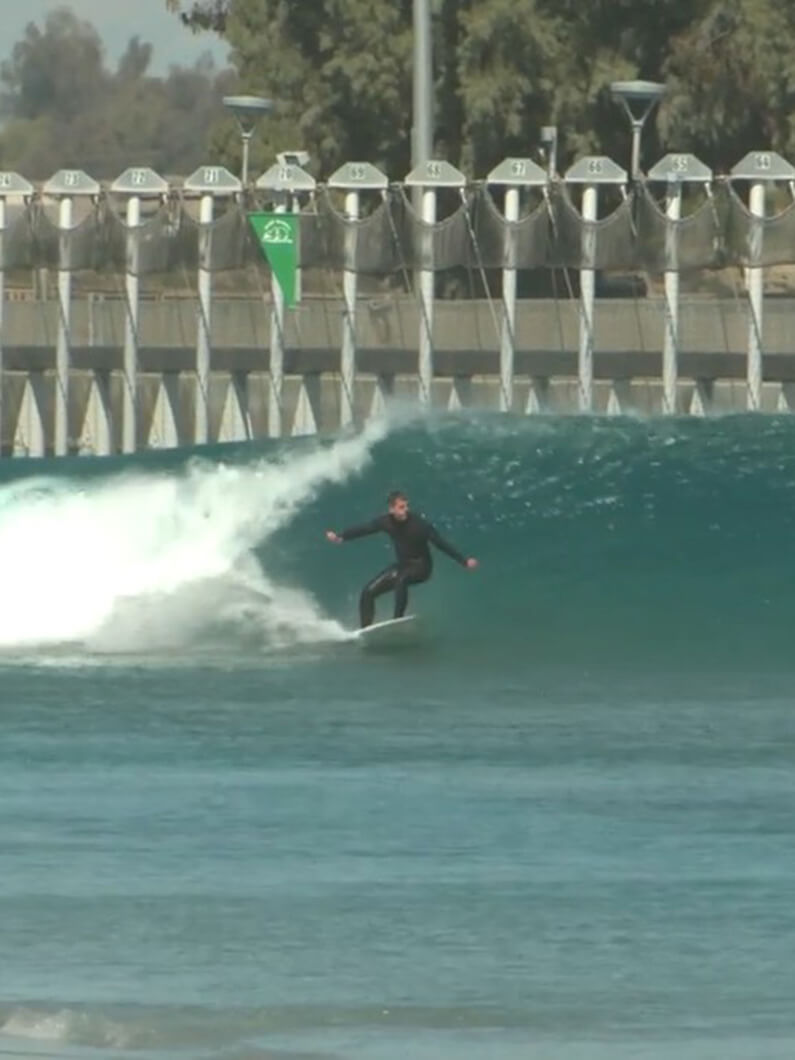 Surfer riding a wave at an artificial wave pool