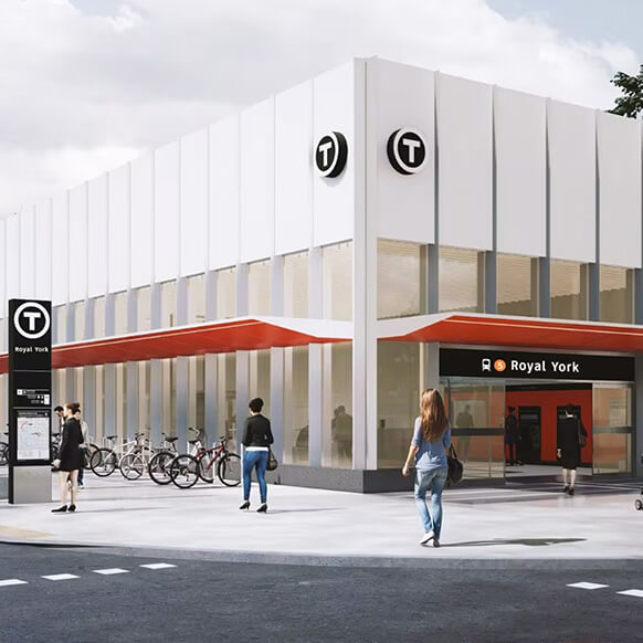 Transit station entrance with modern design and people walking outside. 