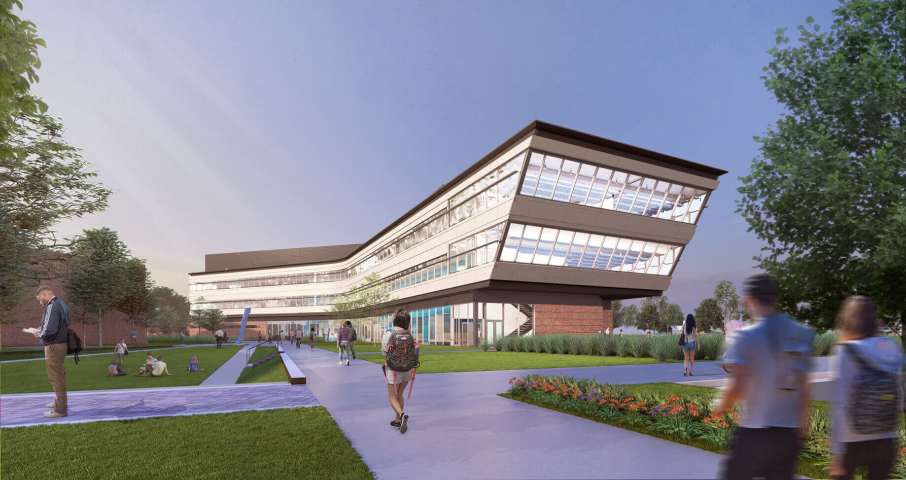Modern building exterior with students walking on campus pathways under a blue sky.