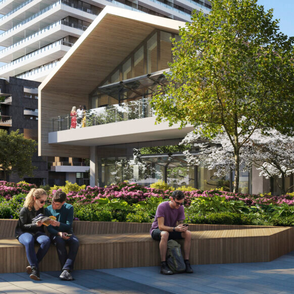 Modern urban park with people relaxing on benches under blooming trees and in front of contemporary architecture.