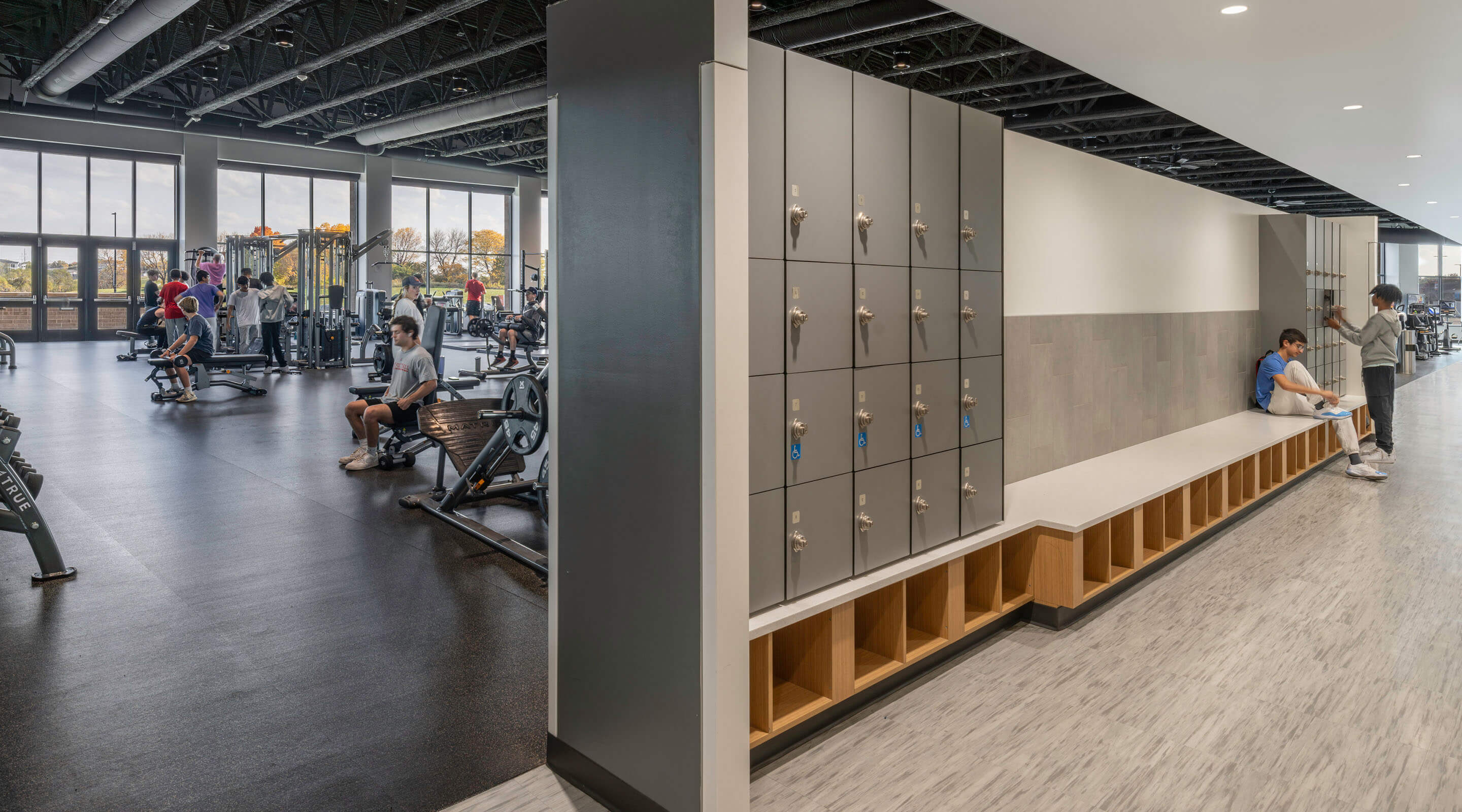 Modern gym with workout equipment and locker area.