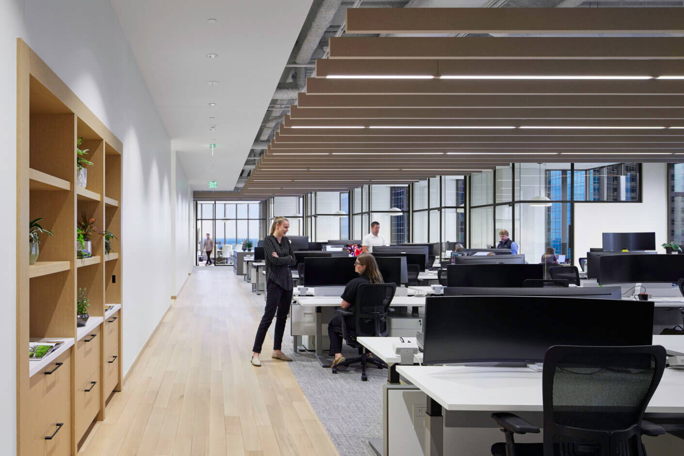 Modern open office space with people working and collaborating.