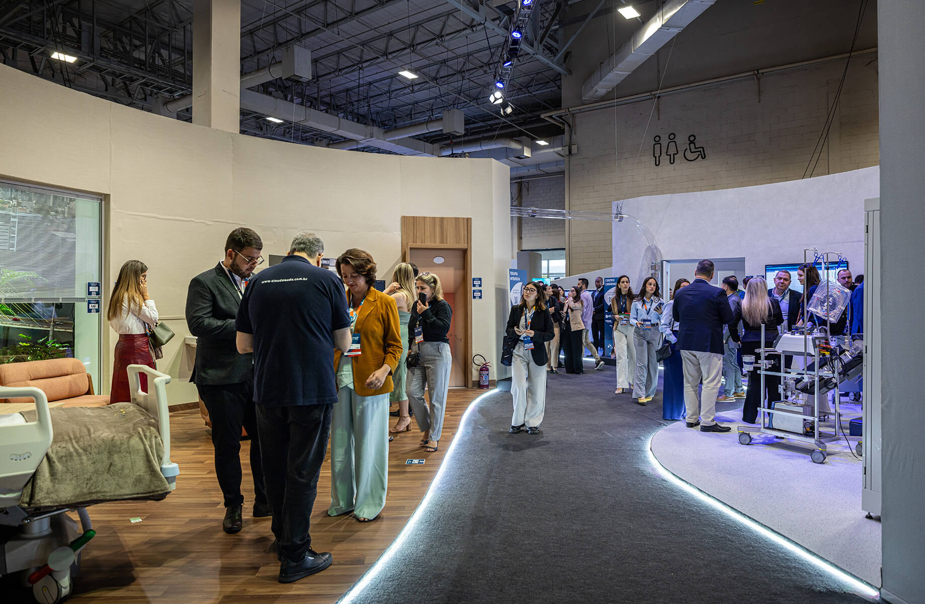 People networking at a medical technology conference exhibit hall.
