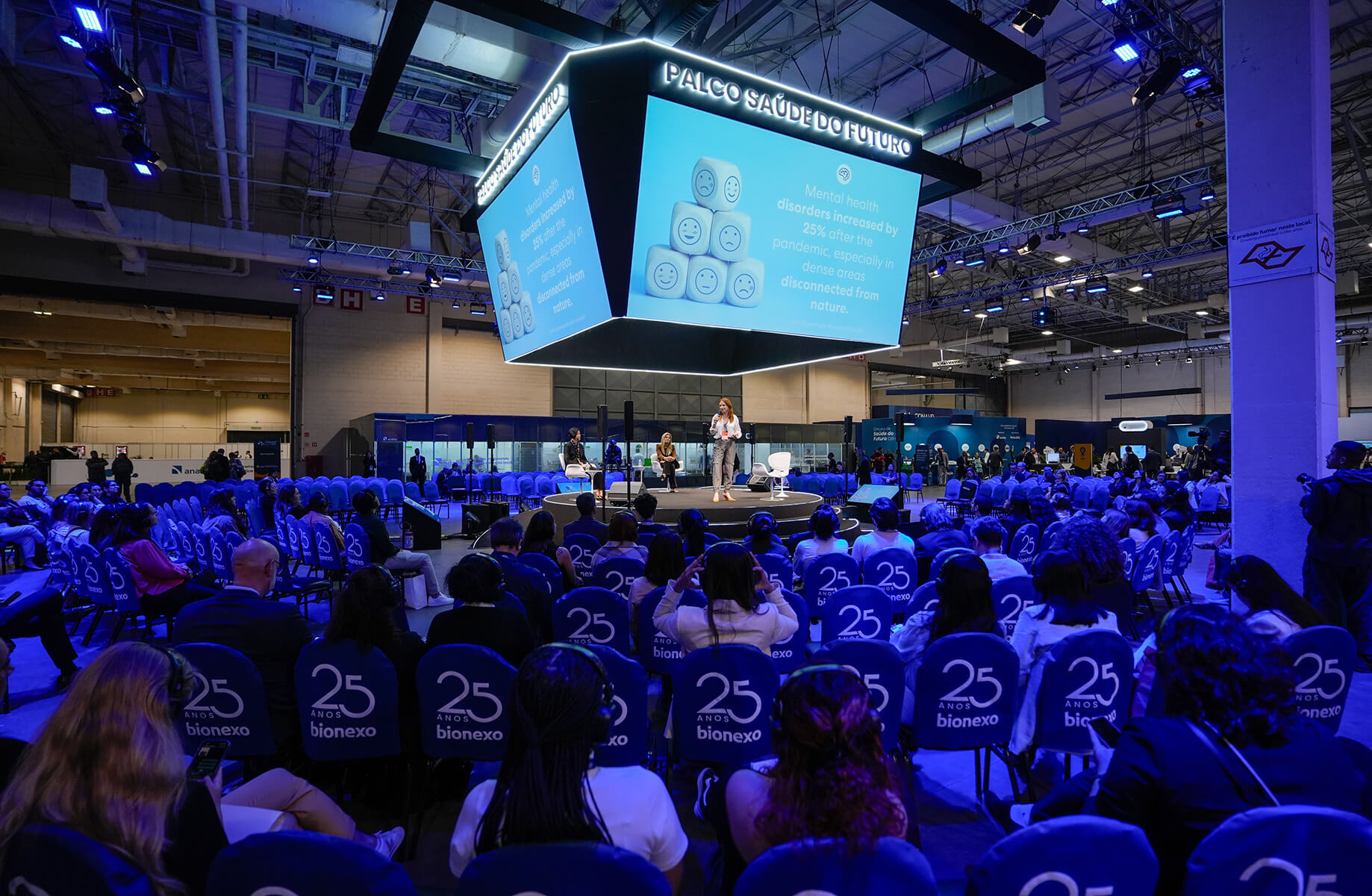 Conference event on mental health awareness post-pandemic with seated audience.