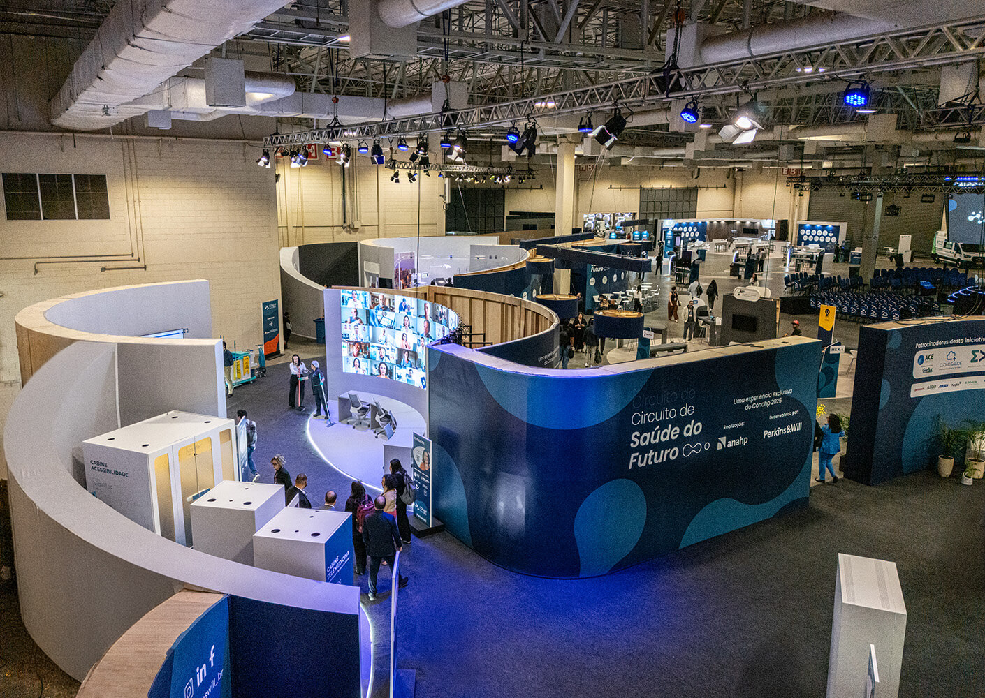 Futuristic health exhibition with blue curved displays and interactive screens.