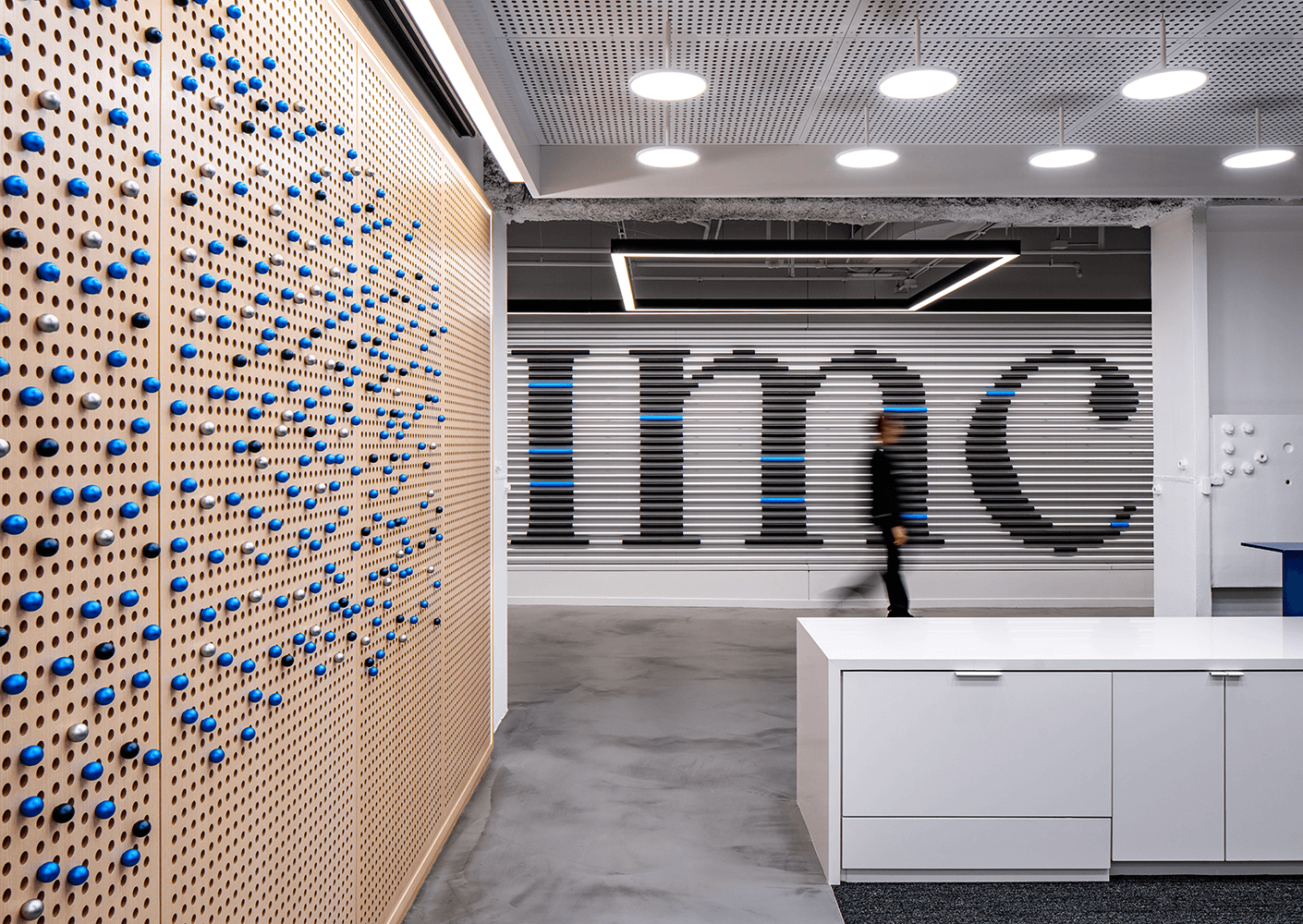 Modern office design with abstract art and wood panel details.