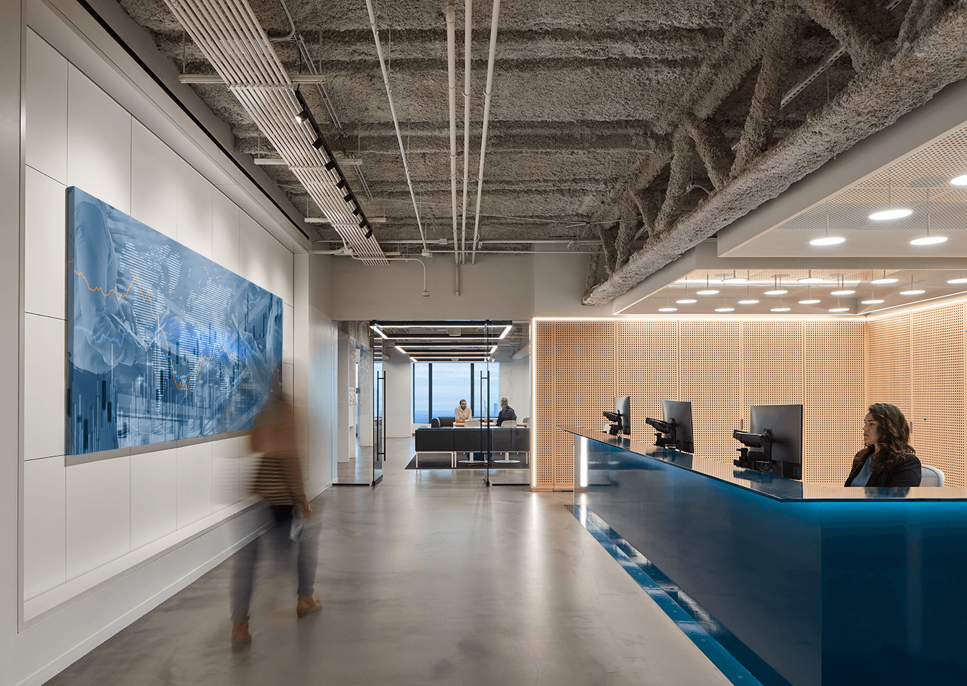 Modern office lobby with digital art and reception desk.