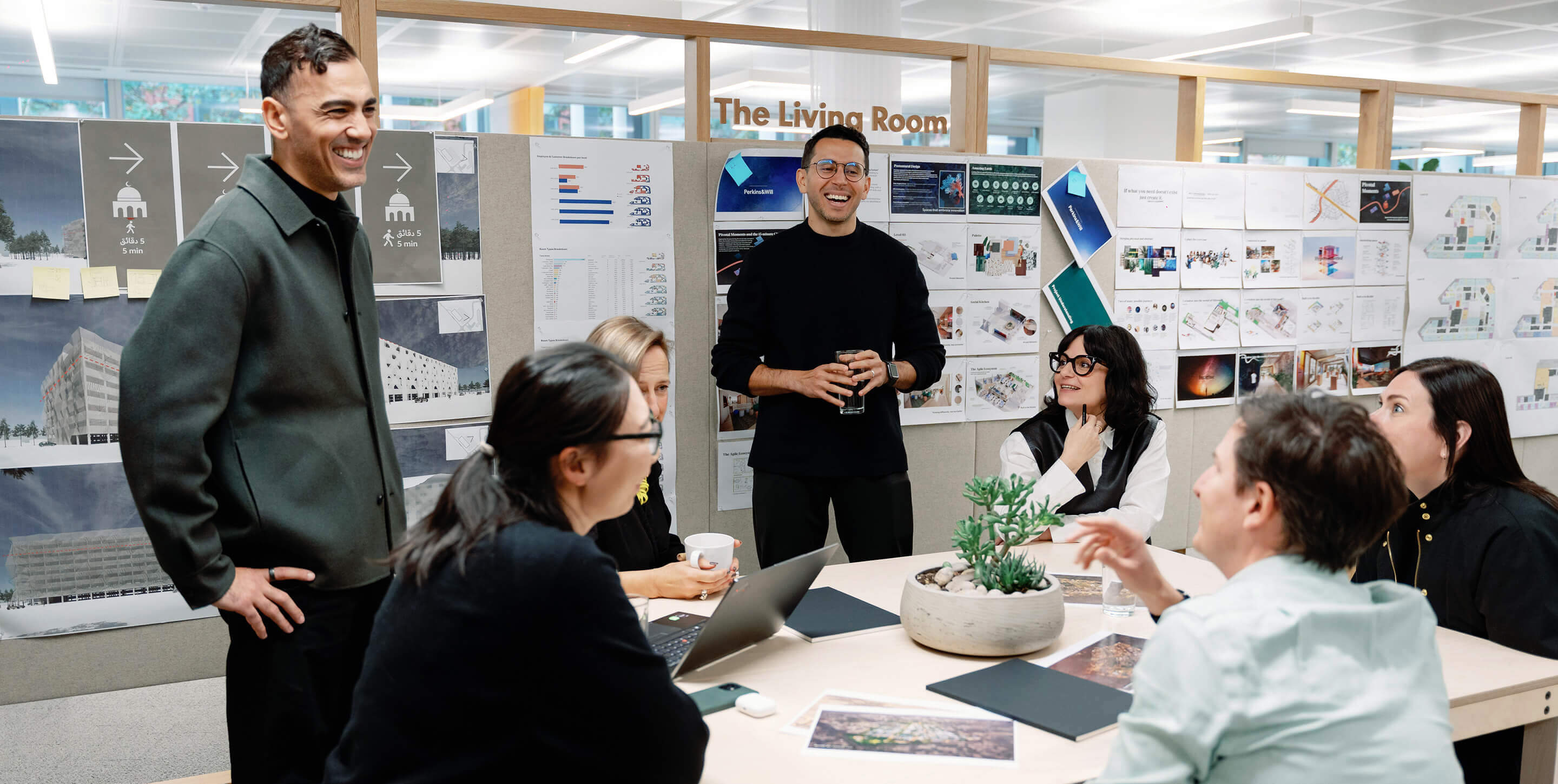 Riyadh team brainstorming in a meeting room with design boards.