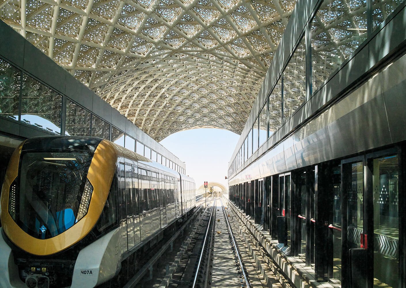 Futuristic train station with modern architecture and glass ceiling.
