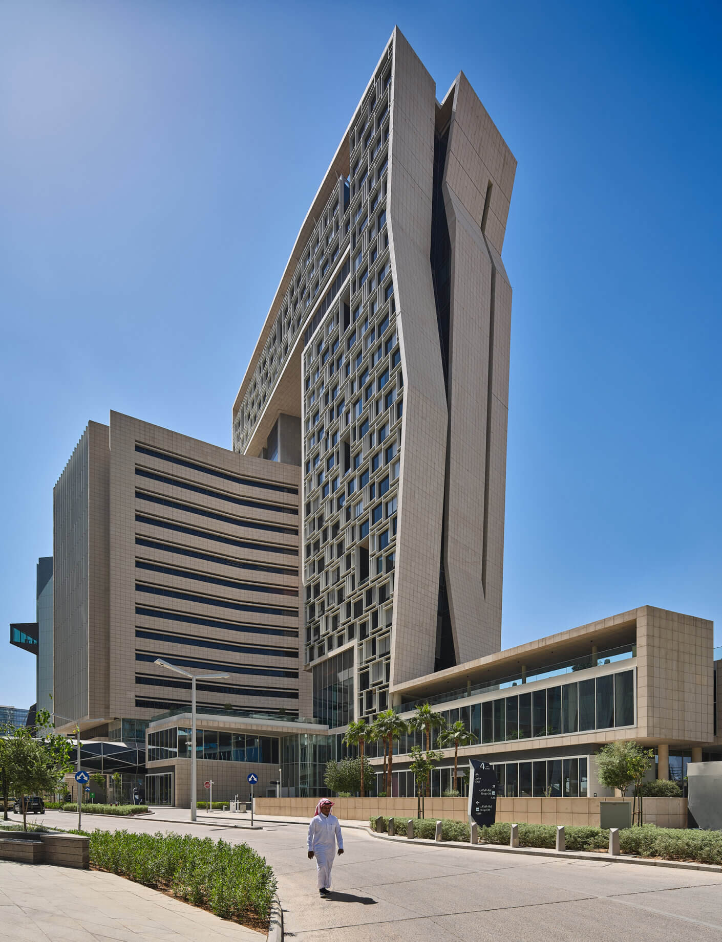 Futuristic high-rise building with sleek design under a clear blue sky.