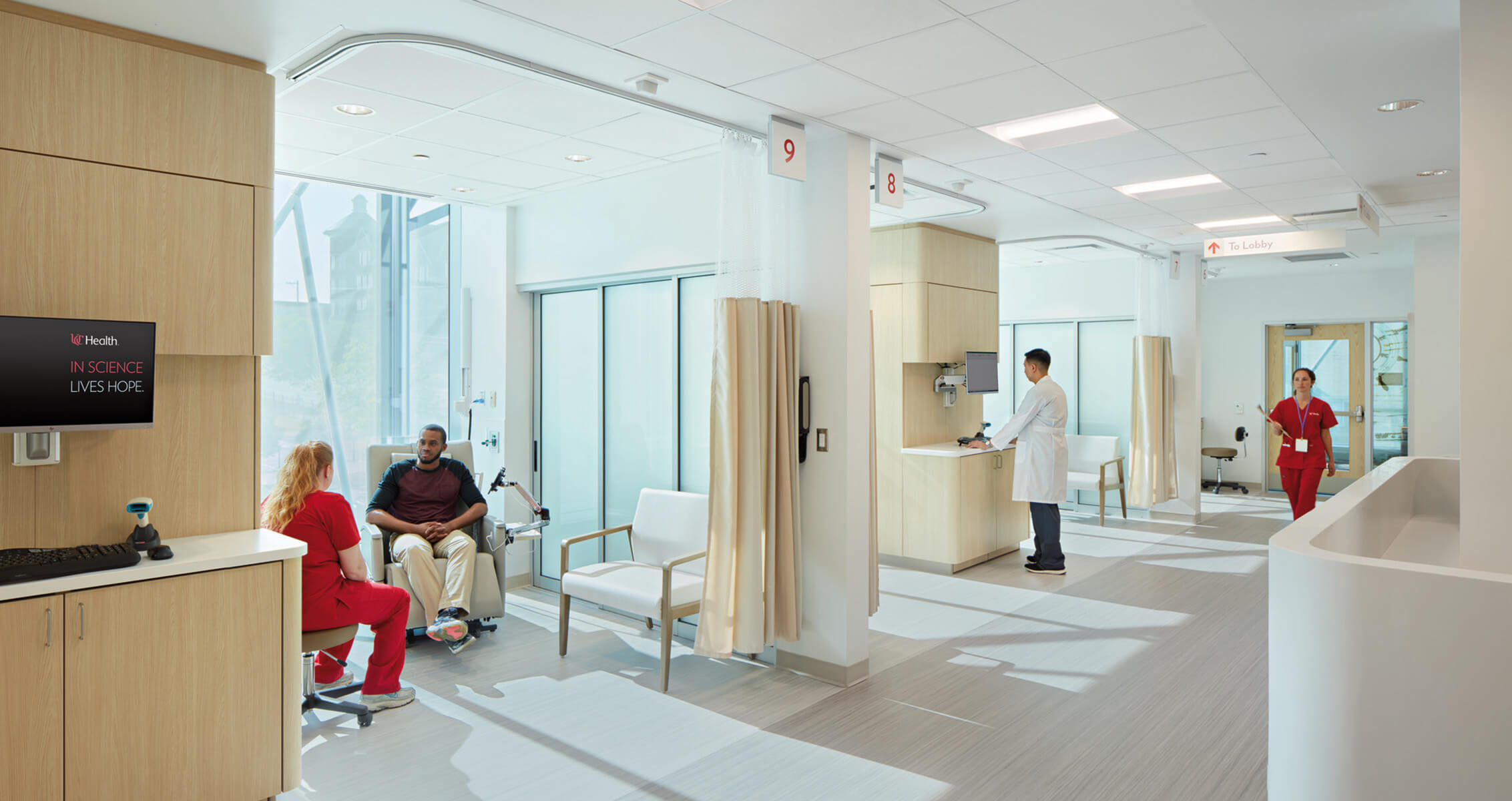 Modern healthcare facility with staff and patient consultation.