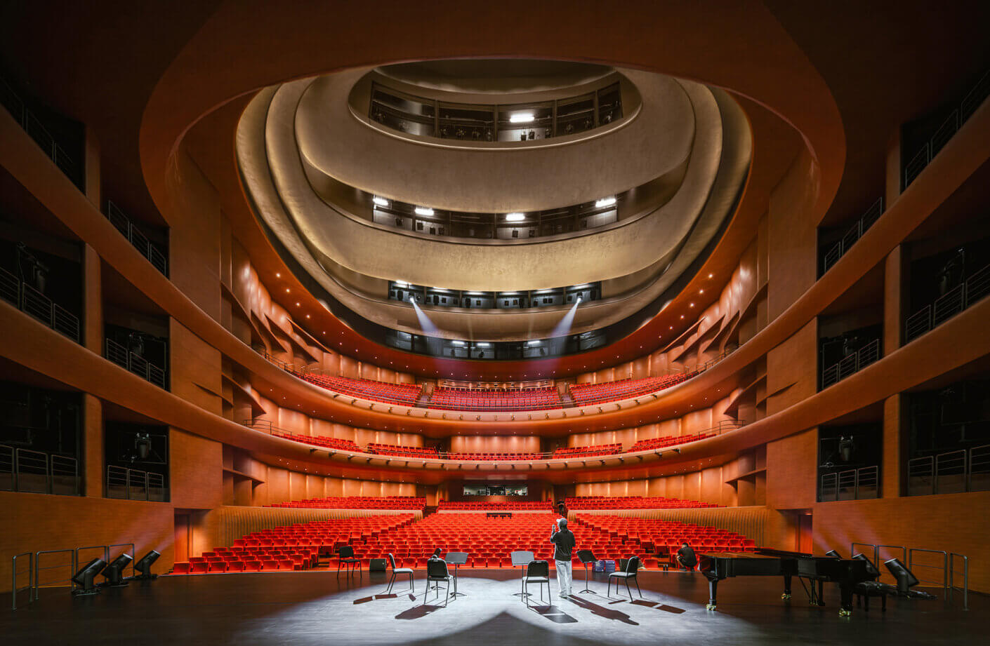 Grand concert hall with red seats and stunning architectural design.