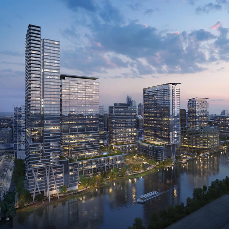 Modern city skyline with illuminated skyscrapers and river at dusk.