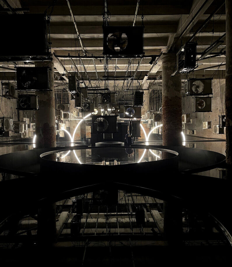 Industrial room with hanging machinery and glowing circular lights.