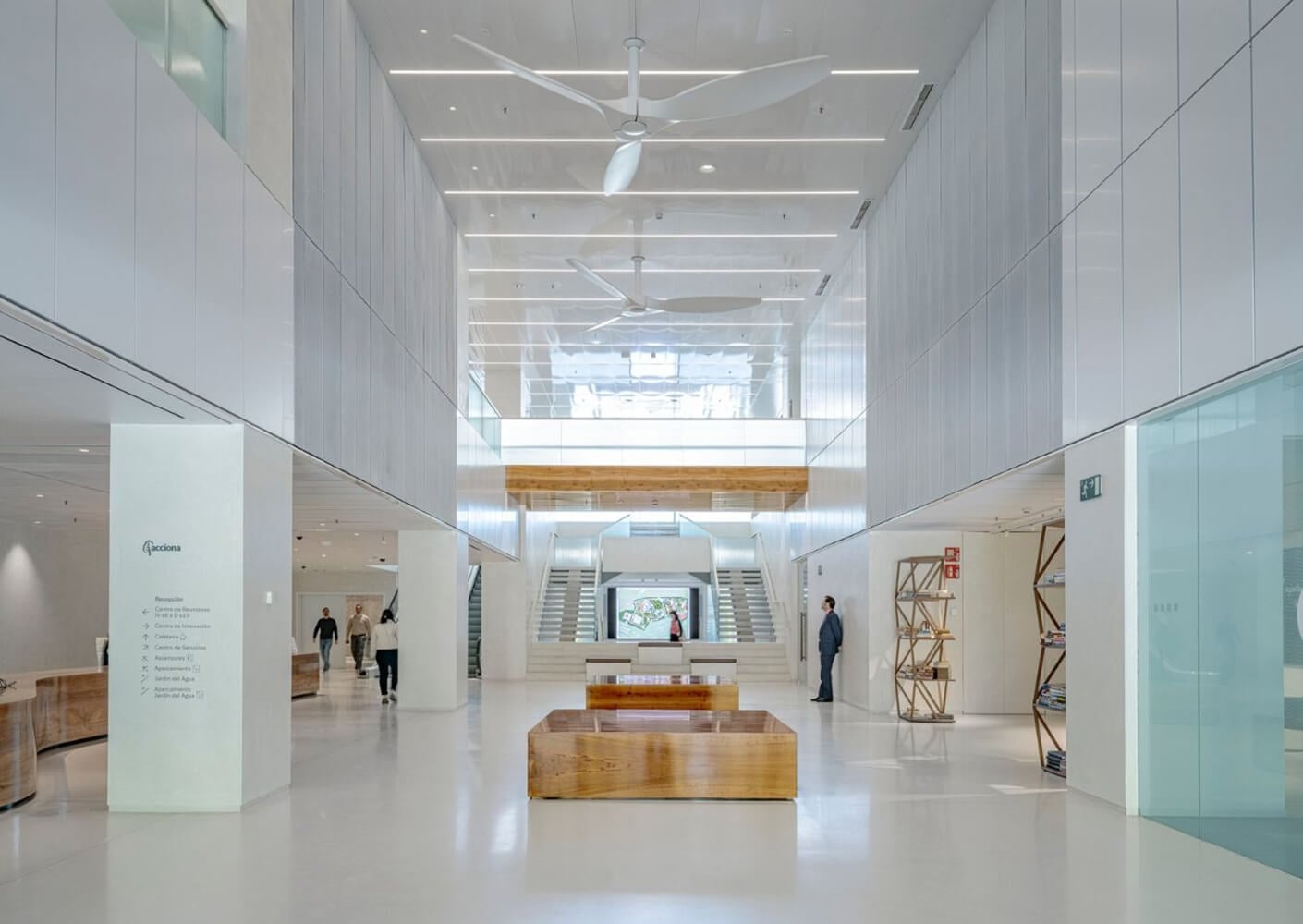 Modern office lobby with high ceilings and elegant wooden features.