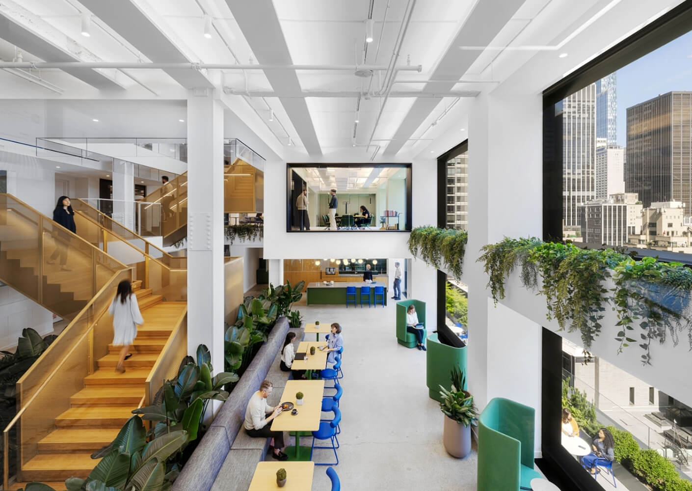 Modern office space with open seating and large windows.