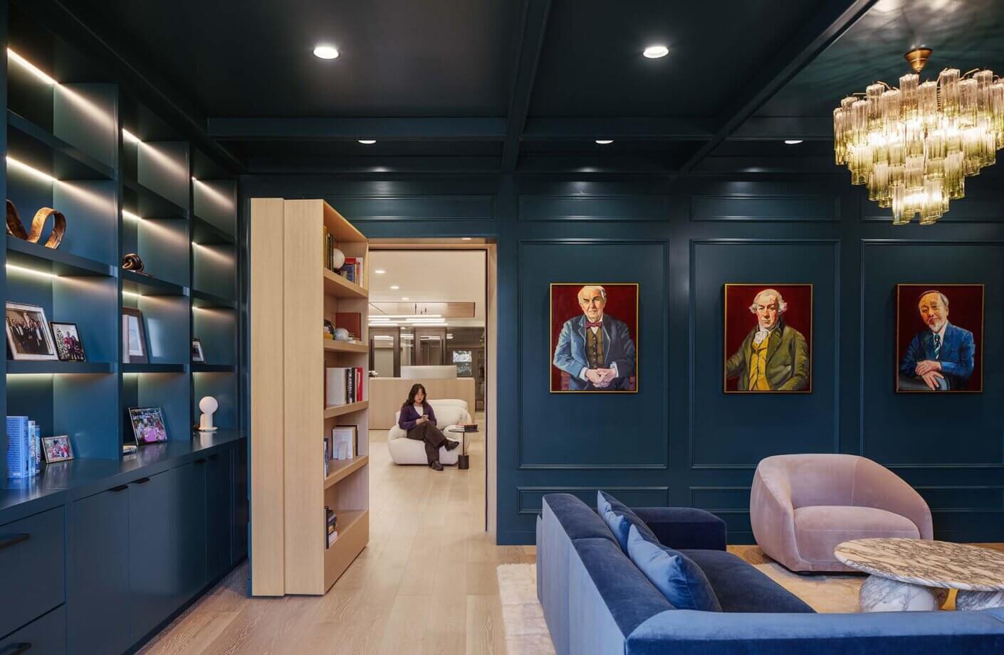 Luxurious library with art, bookshelves, and cozy reading nook.