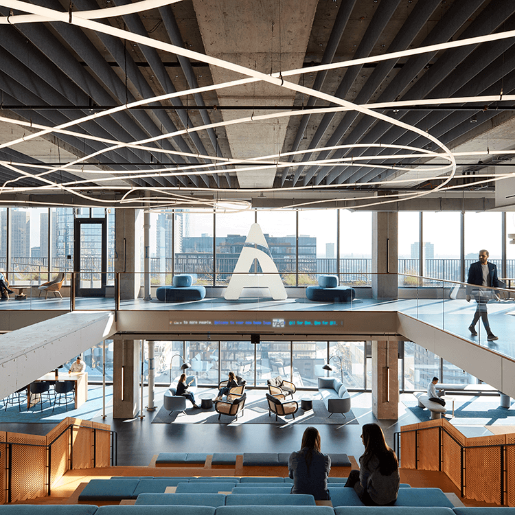 Modern office space with large windows and innovative lighting design.