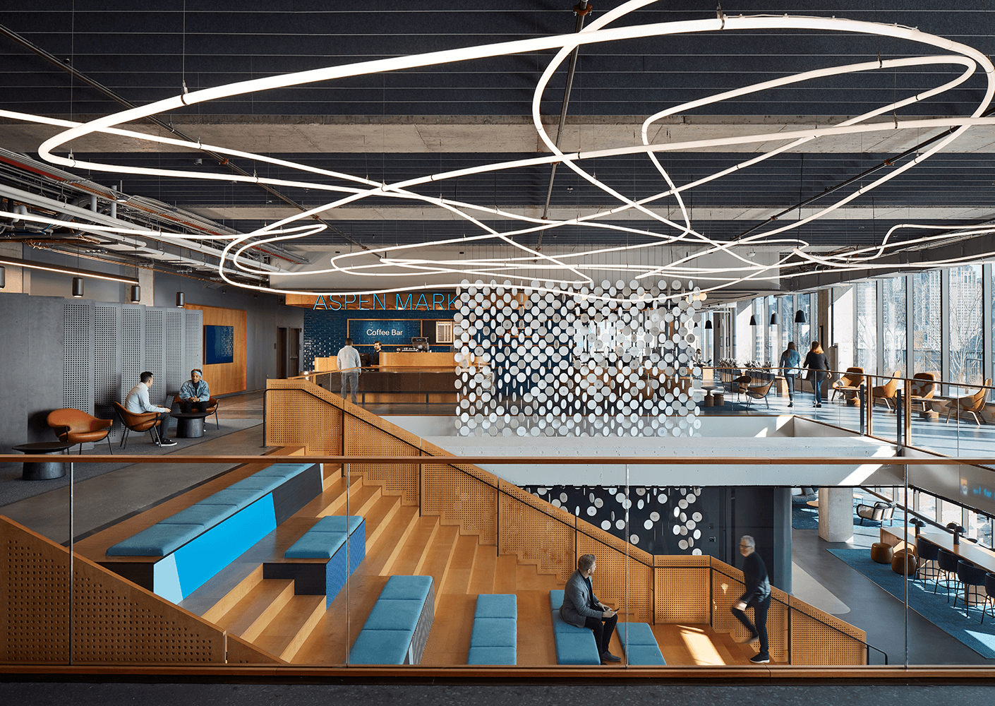 Modern office lobby with seating, lighting, and coffee bar. Contemporary workspace design.