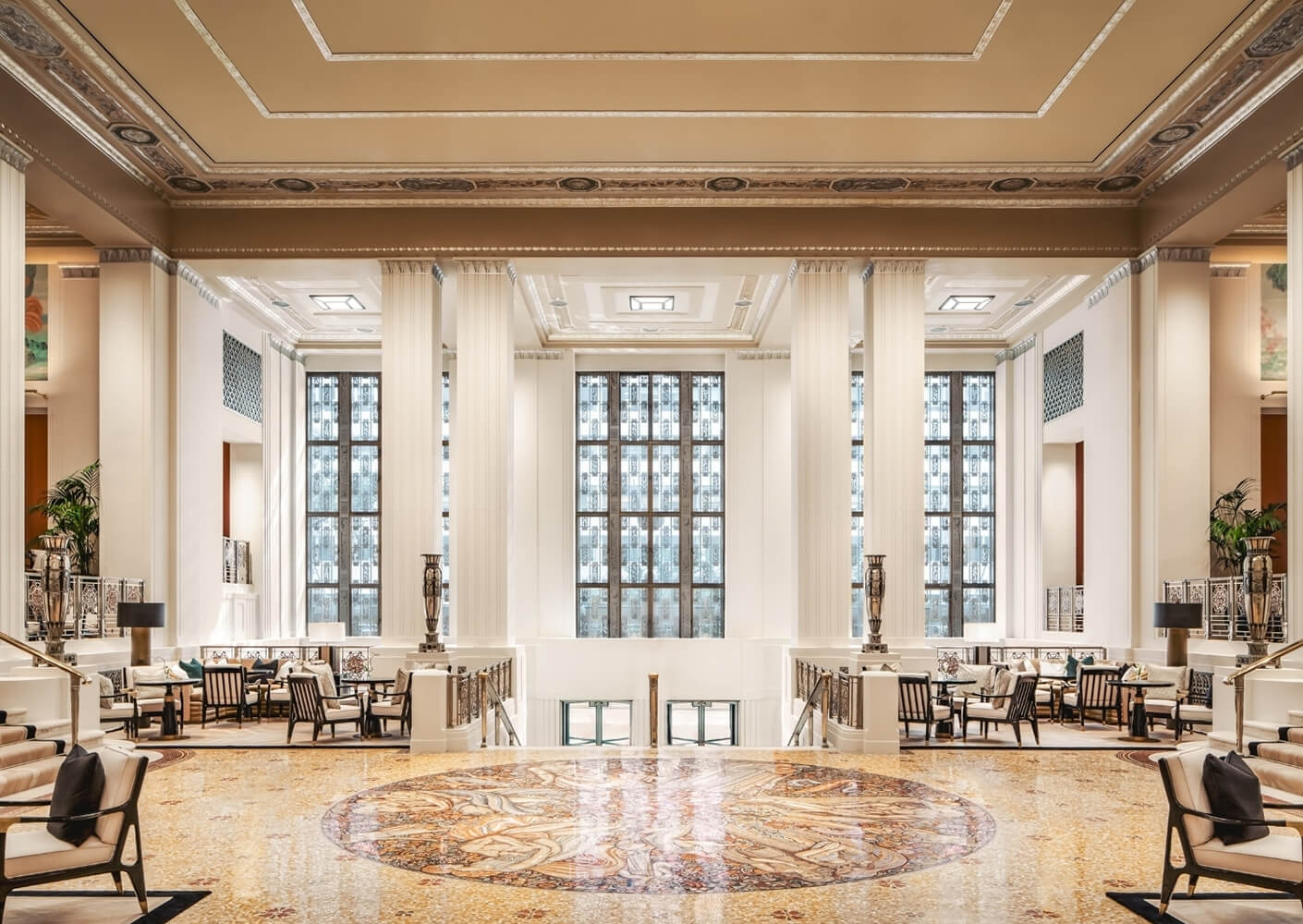 Luxurious hotel lobby with elegant decor and grand columns.