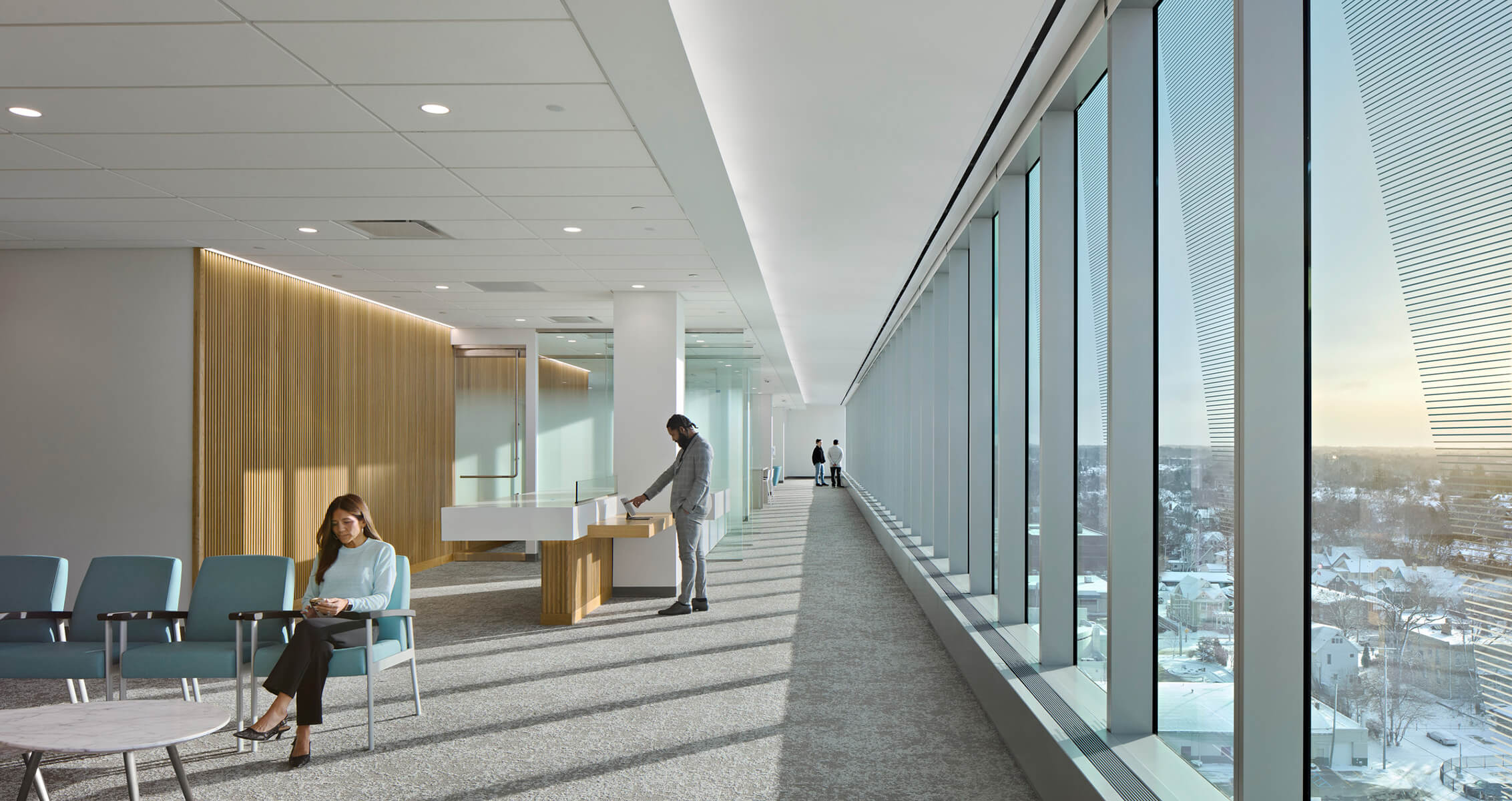 Hospital interior with large windows and wooden walls and seating