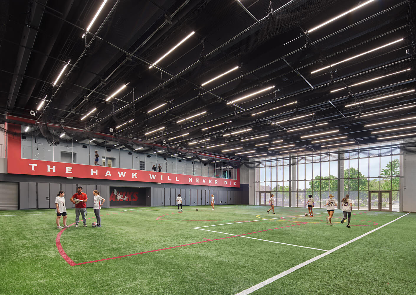 Indoor turf field with players practicing at St. Joseph's University.