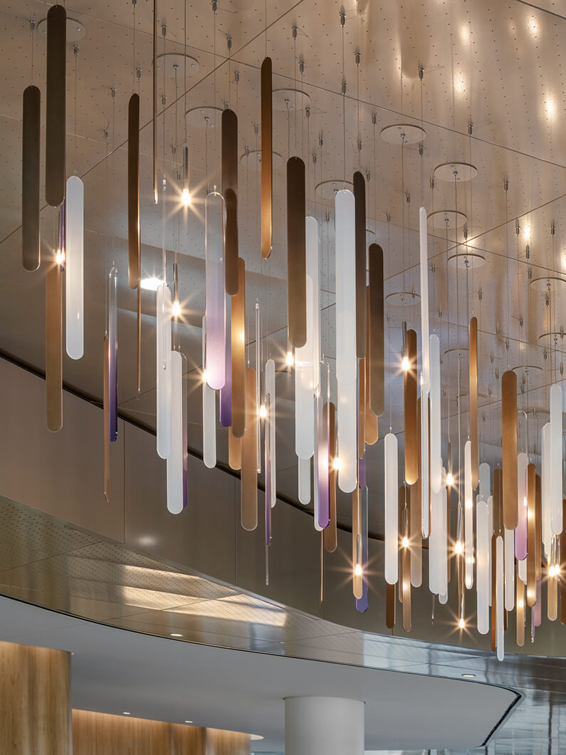 Modern chandelier with hanging lights and geometric design in stylish interior.