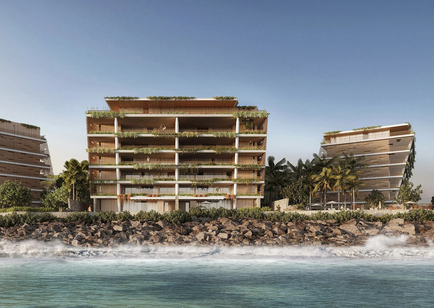 Modern beachfront building with garden balconies and ocean view.