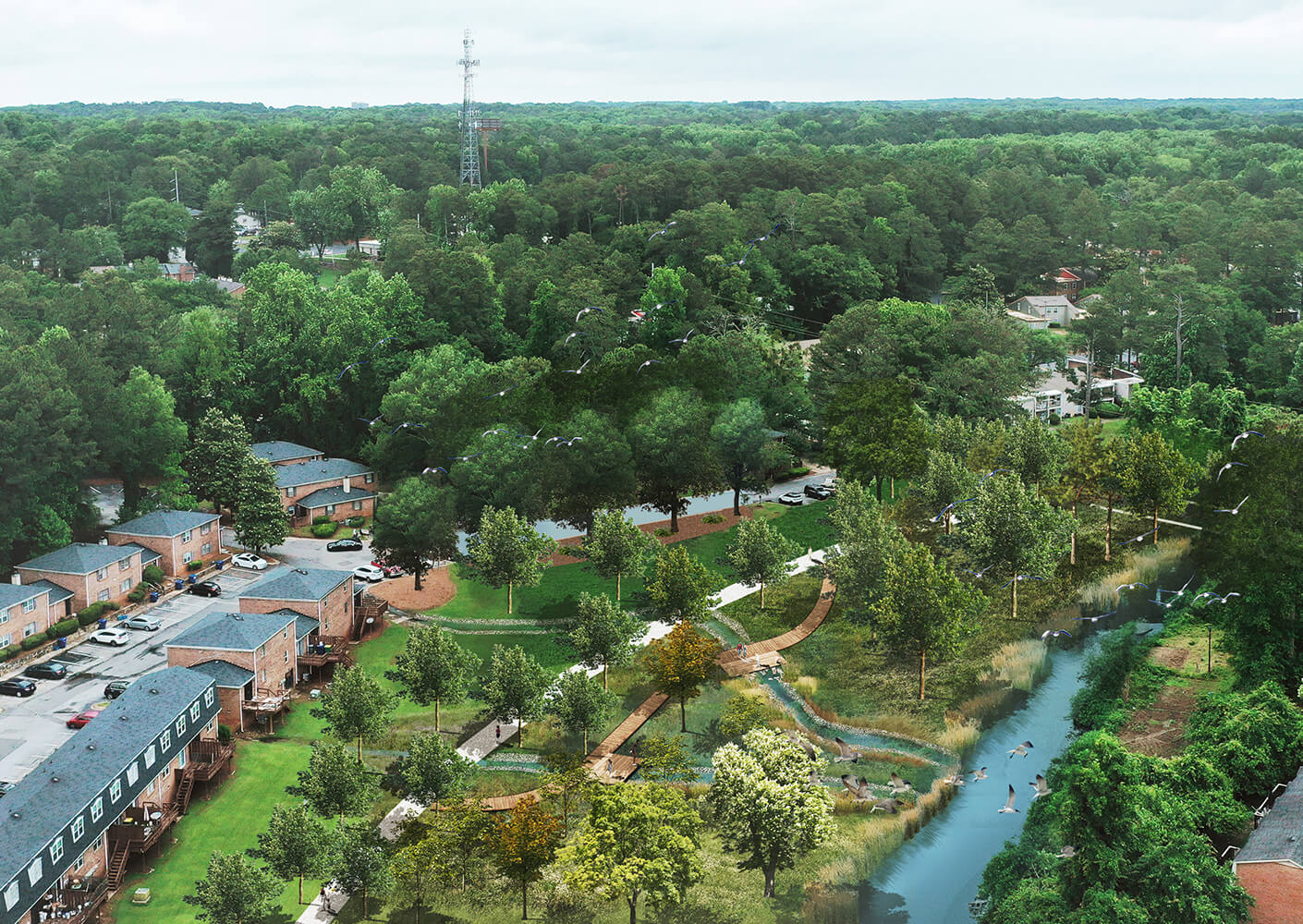 Aerial view of residential area with lush greenery and a winding river.