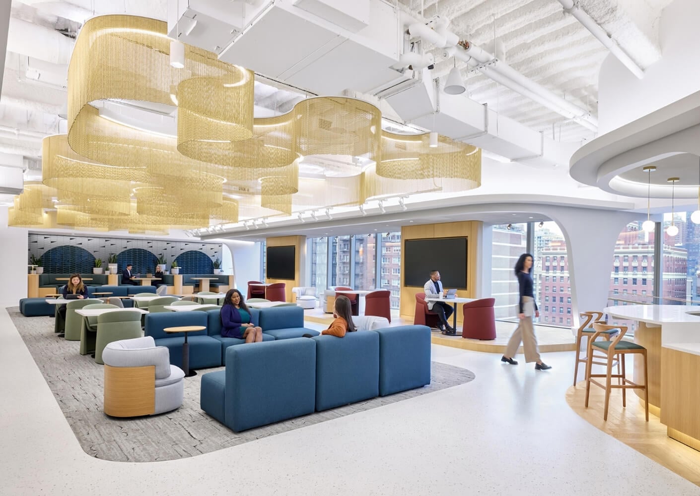 Modern office lounge with contemporary furniture and unique ceiling design.