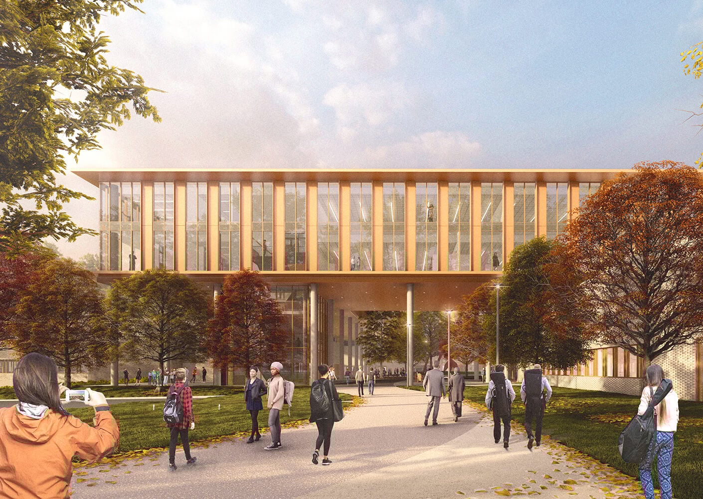 Modern building exterior with people walking in autumn setting.