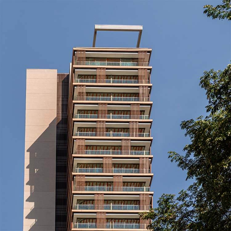 Modern high-rise building against clear blue sky.